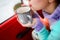 Young woman drinking hot tea close-up. Getting warm