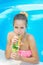 Young woman drinking lemonade in the pool