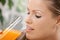 Young woman drinking orange juice