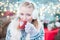 Young woman drinking punch on christmas market