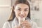 Young woman drinking pure glass of water