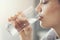 Young woman drinking pure glass of water