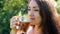 Young woman is drinking tea with mint outdoor.