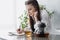 Young woman drinking tea and writing down thoughts