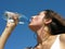 Young woman drinks cold water on a hot day