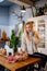 A young woman drinks hot cocoa sitting on the kitchen table. Christmas pastries.