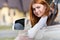 Young woman driving a car backwards. Girl with funny expression on her face while she made a fender bender damage to a rear