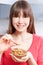 Young Woman Eating Almonds From Bowl