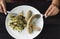 Young woman eating Bavarian sausages with salad of fresh vegetables