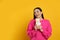 Young woman eating delicious shawarma on yellow. Space for text