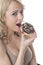 Young Woman Eating Iced Donut