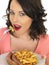 Young Woman Eating Jumbo Sausage and Chips