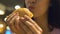 Young woman eating junk food hamburger and smiling, delicious unhealthy meal