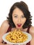 Young Woman Eating a Large Plate of Fried Chips