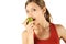 Young woman eating pear