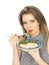 Young Woman Eating Poached Slamon and Salad