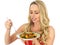 Young Woman Eating a Roast Vegetable Salad