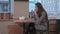 Young woman eating sandwich in the cafeteria with pleasure