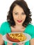 Young Woman Eating Saveloy Sausage and Chips