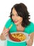 Young Woman Eating Saveloy Sausage and Chips