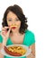 Young Woman Eating Saveloy Sausage and Chips