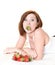 Young woman eating strawberries on bed