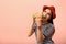 Young woman eating tasty burger on color background.