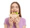 Young woman eating tasty sandwich on white