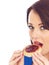 Young Woman Eating Toasted Crumpet and Jam