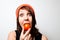 Young woman eating tomato