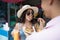 Young Woman Eating Traditional Street Food From Male Hands Young Couple Of Tourists Walking In Asian City