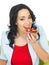 Young Woman Eating Wholewheat Cracker with Chocolate Spread and Fresh Sliced Strawberries