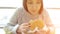 Young woman eats a burger. Harmful fatty foods