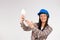 Young woman electrician holds an LED lamp in her hands and posing on white background. Idea , space for an advertisment