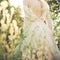 Young woman in elegant dress, bare back,  summer day in field