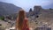 A young woman embarks on a cultural journey as she explores the breathtaking ruins of Termessos, nestled within the