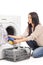 Young woman emptying a washing machine