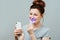 A young woman is engaged in home teeth whitening. Complex for teeth whitening with UV lamp