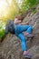 A young woman is engaged in rock climbing. Leisure and active sports. Light. Bottom view