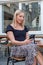 Young Woman Engrossed in Her Smartphone at a Cafe