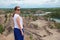 Young woman enjoy beautiful view of lake and grren trees in closed sand quarry.