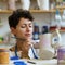 Young woman enjoy painting clay jug with paint after shaping and sculpturing earthenware potter jar