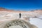 Young woman enjoying the amazing geyser of the Bolivia Altiplano, between Chile and Bolivia, more than 5 thousands meters above th