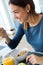 Young Woman Enjoying Breakfast in the kitchen