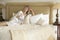 Young Woman Enjoying Champagne In Bedroom