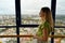 Young woman enjoying cityscape on the panoramic tower of Curitiba, Parana, Brazil