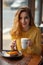 Young woman enjoying a cup of coffee and a slice of delicious ca