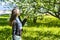 Young woman enjoying the fragrance of apple-tree