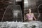 Young woman enjoying hydro massage in spa pool