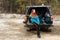 Young woman enjoying nature while sitting in the car trunk